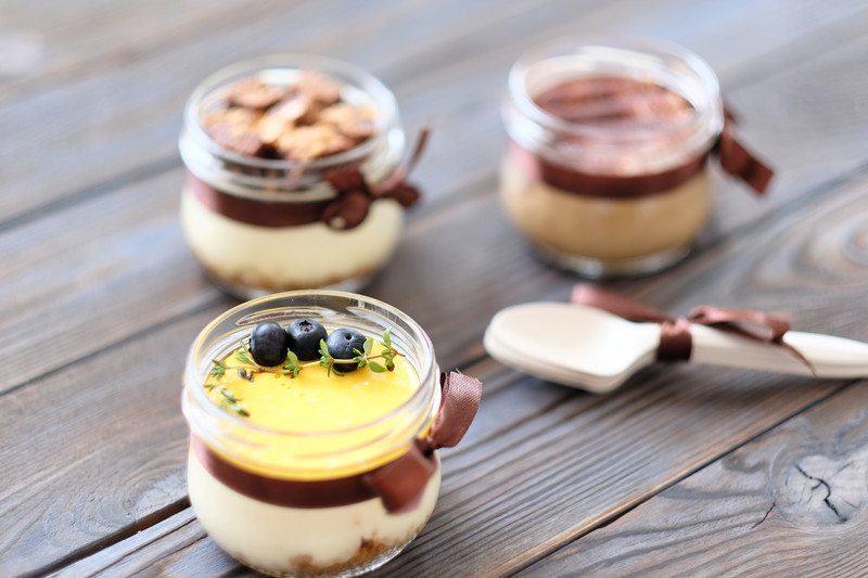 chocolate, yogurt, and blueberries on a sous vide cream-based dessert with spoon