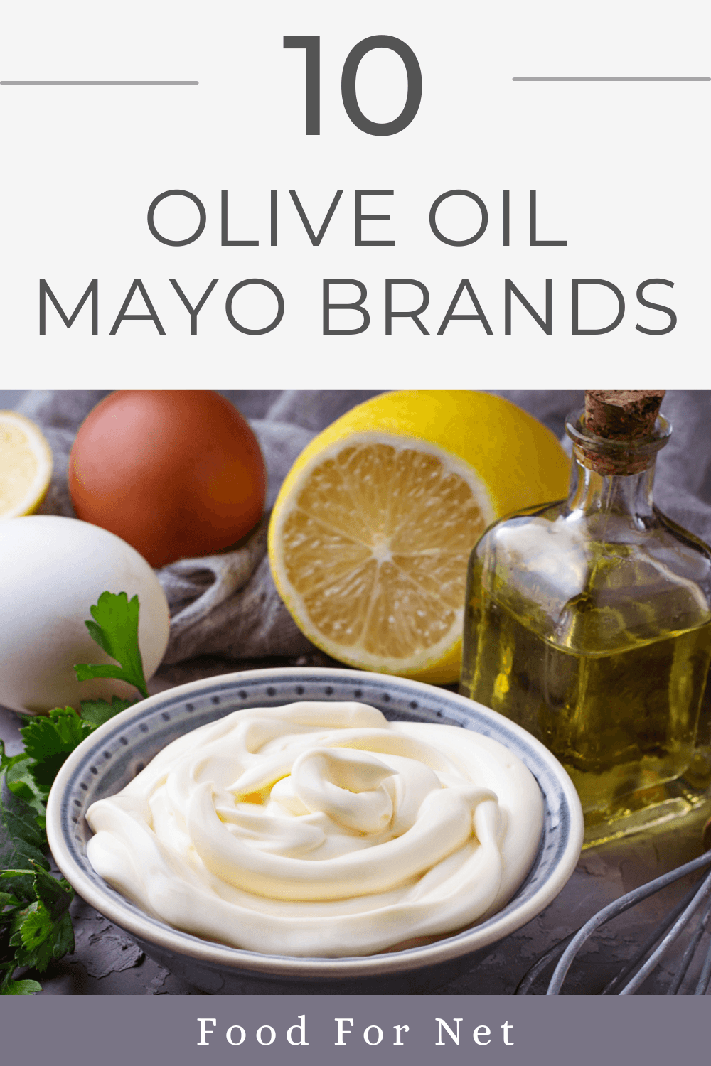 A bowl containing olive oil mayo, next to a bottle of olive oil, a lemon, and some eggs, looking at the best olive oil mayo brands