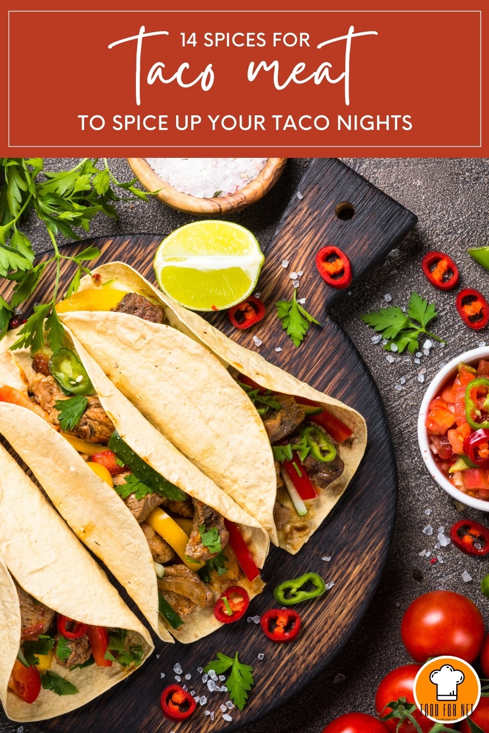 top view image of a beautifully plated tacos on a round wooden board with fresh salsa, cherry tomatoes, lime, rock salt, parsley, and chopped red chilis around it; with text at the top in dark red background "14 Spices for Taco Meat to Spice Up Your Taco Nights"