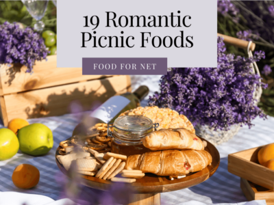 A selection of romantic picnic foods, including croissants, pretzels, and wine, surrounded by fruit and lavender.