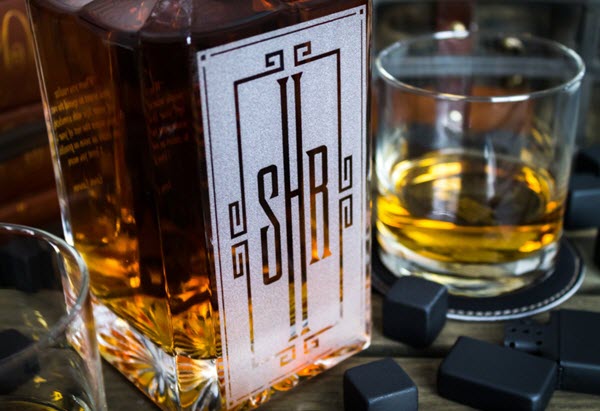 2 Side Engraved Whiskey Decanter | Food For Net A whiskey decanter, some glasses, whiskey stones and a lighter