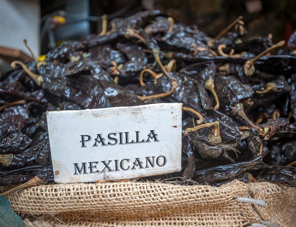 pasilla de oaxacana chile in a pile sold in a market