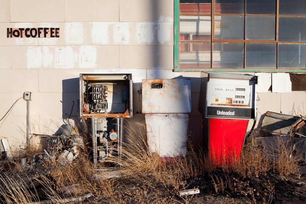 Hot coffee written on the wall, in front of disused gas pumps