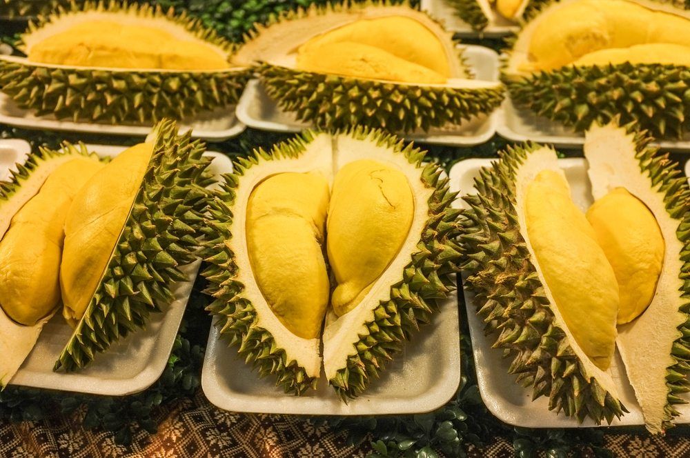 Paper or plastic plates, each with half of a durian fruit