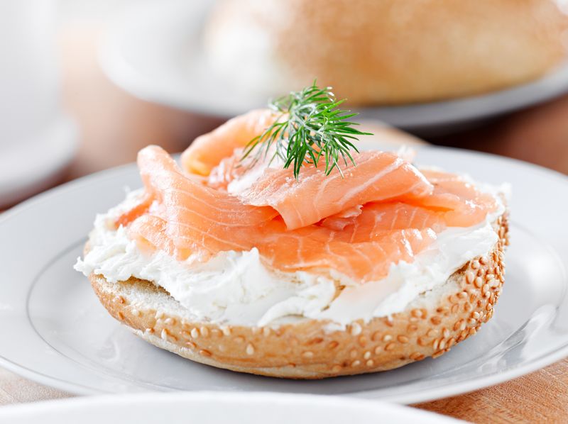 Half a bagel with cream cheese and salmon