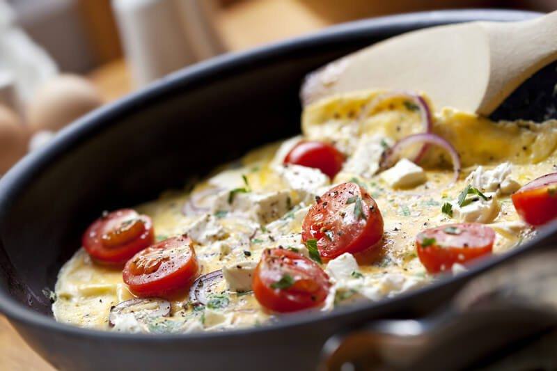 Omelet in a pan with tomatoes and cheese