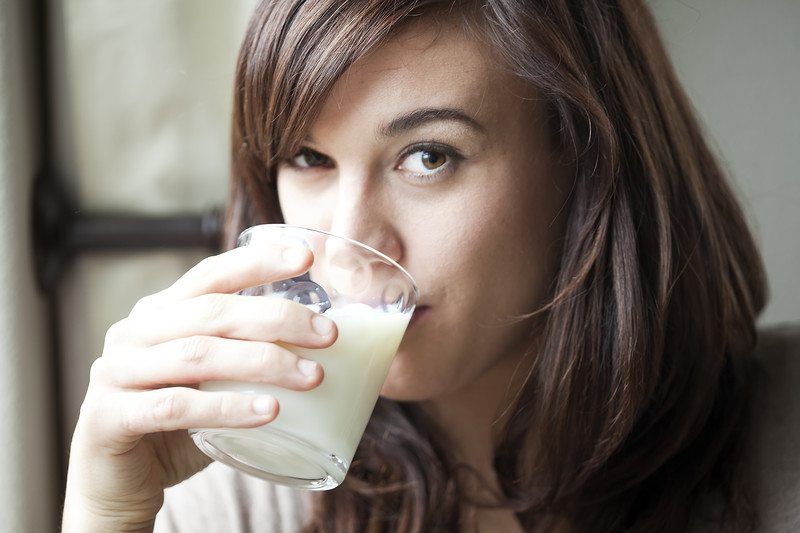 Young woman drinking milk