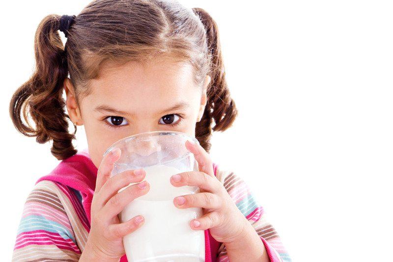 Young girl drinking milk