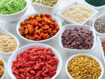 Selection of superfoods in white bowls