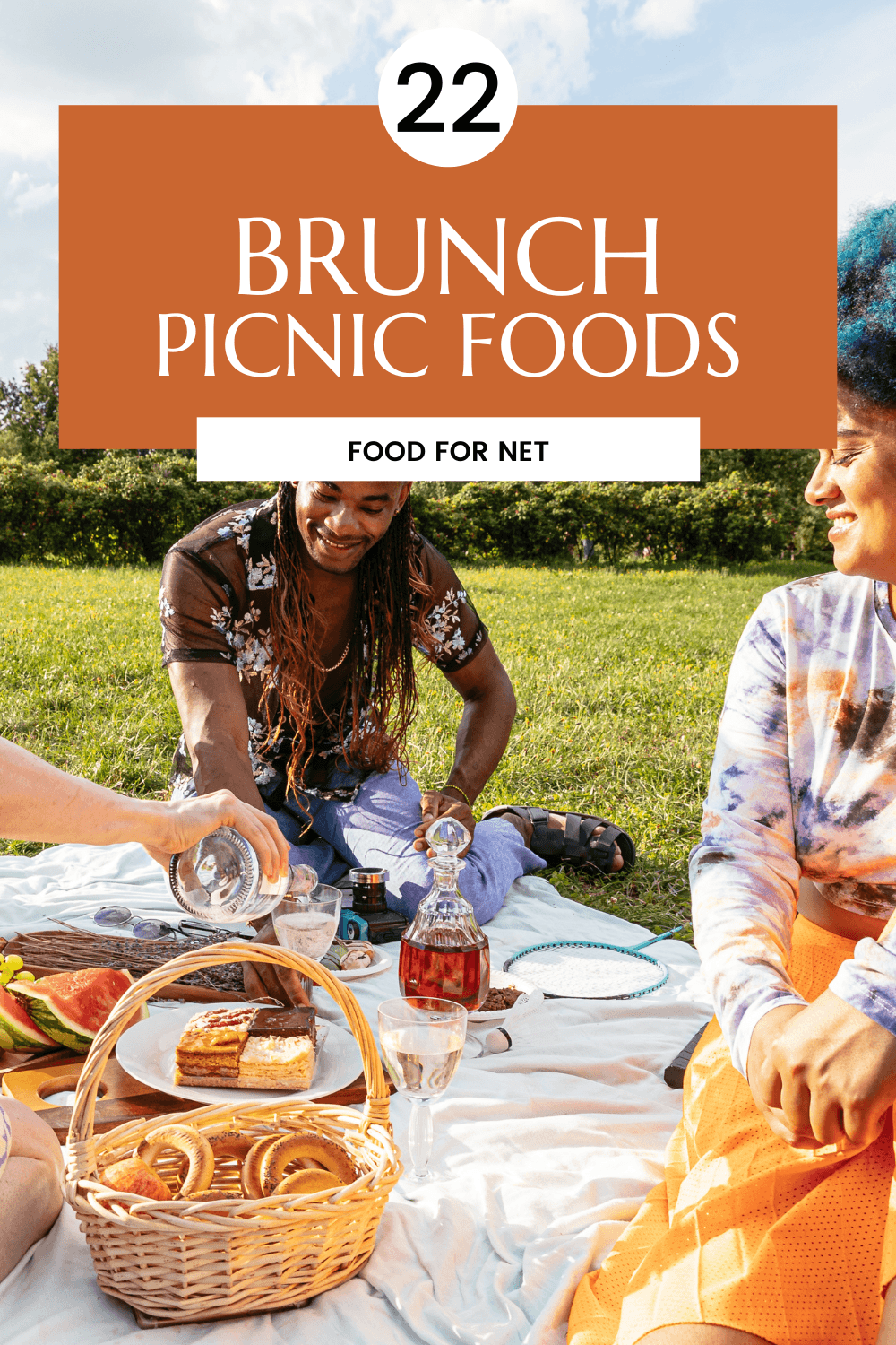 Brunch Picnic Foods. A group of people outside sitting on a blanket having a brunch picnic