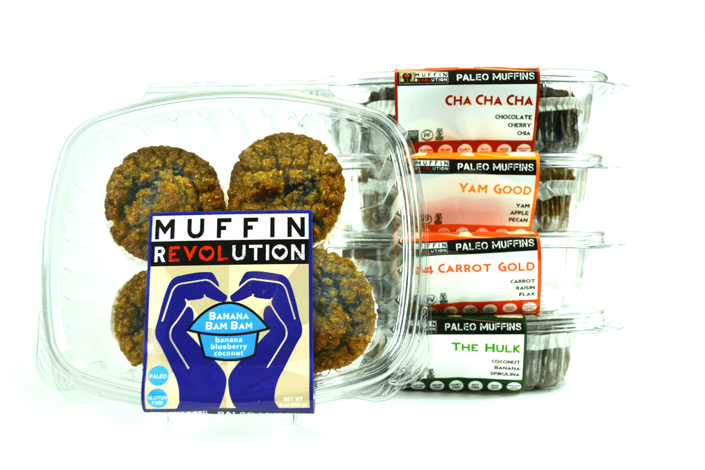 5 packages of Muffins, with four muffins per container.  All of the containers have muffin revolution labels.  the front container on its side is Banana Bam Bam, then in the back from top to bottom cha cha cha, next yam good, next Carrot gold and the bottom container is The Hulk