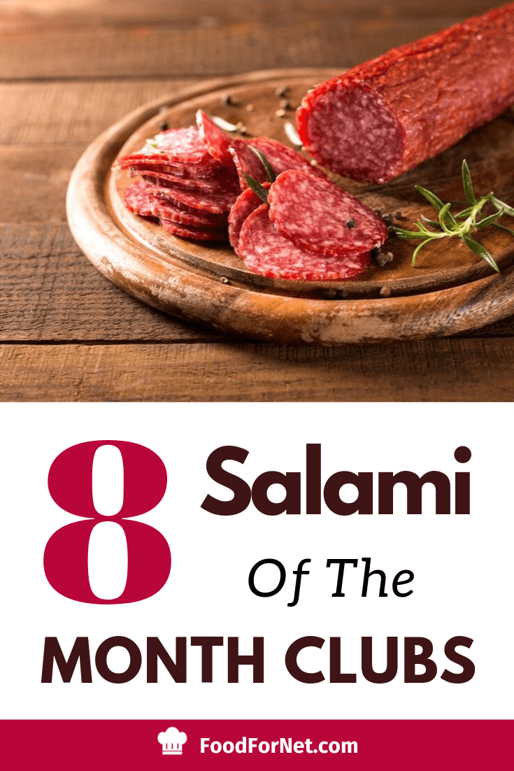 sliced salami on a wooden cutting board with rosemary and cracked pepper