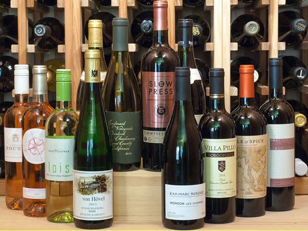 12 wine bottles against a wine rack