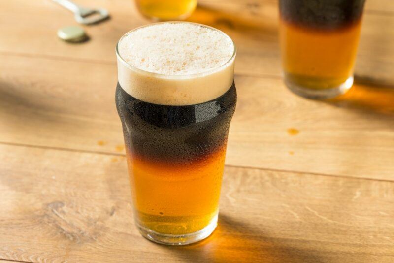 Two Guinness black and tan cocktails on a light table