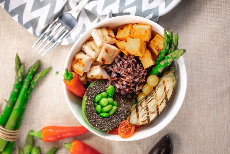 A power bowl with avocado, chicken and protein ingredients