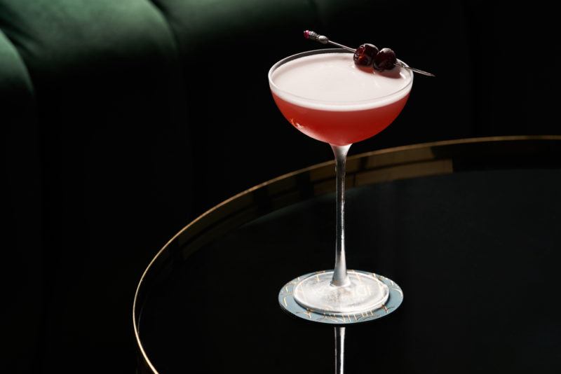 A Jack Rose cocktail on a table in a bar