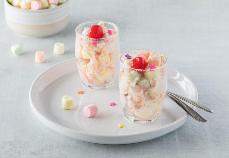 A white plate with two jars that contain a Jell-O fluff salad