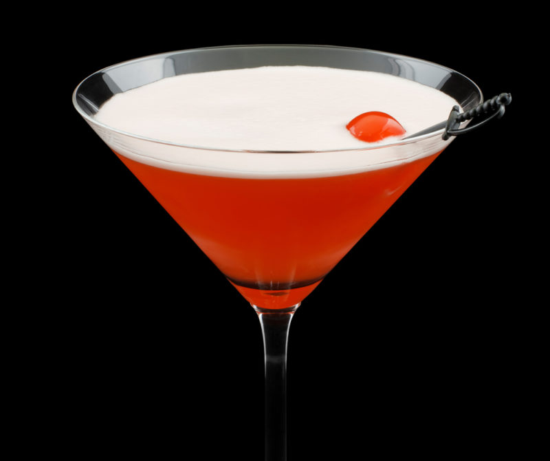 A cocktail glass with a red Mary Pickford cocktail