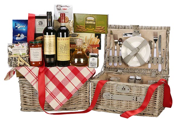 Expansive gift basket with wine, snacks and pasta sauce on the top. 