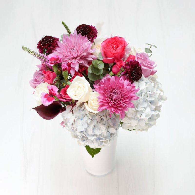 A Signature Collection bouquet from Enjoy Flowers with pink and white blooms in a white vase