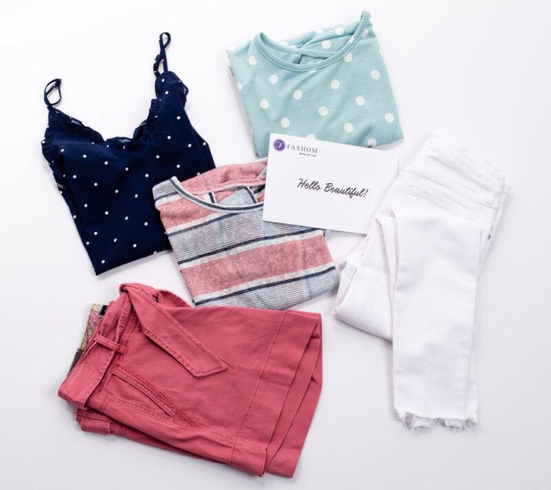 Various items from Fashom against a white background, including a shirt and a pink skirt or shorts