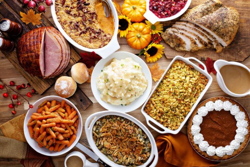 A full Thanksgiving meal that includes ham, turkey, and various sides