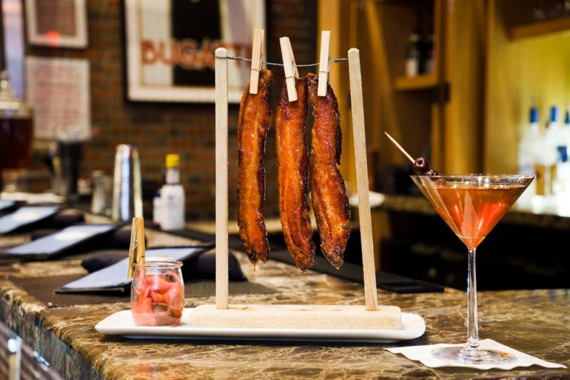 A bacon martini with bacon and ginger on a bar