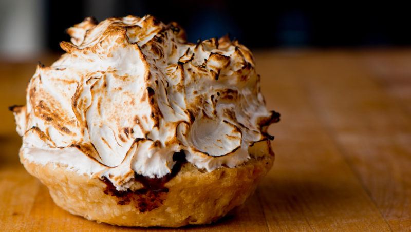 A baked Alaska on a wooden table