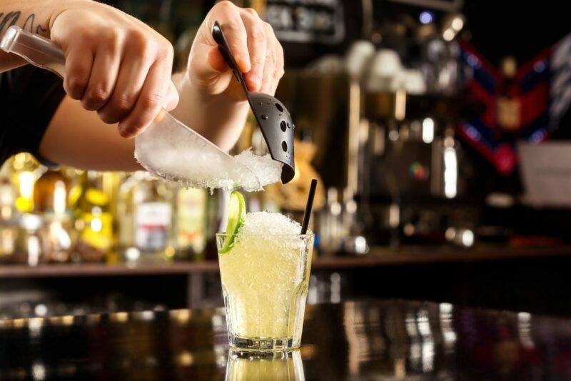 A bartender preparing a 7 Up rum rambler using plenty of crushed ice