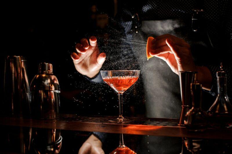 A bartender preparing the Winston cocktail in a dark room