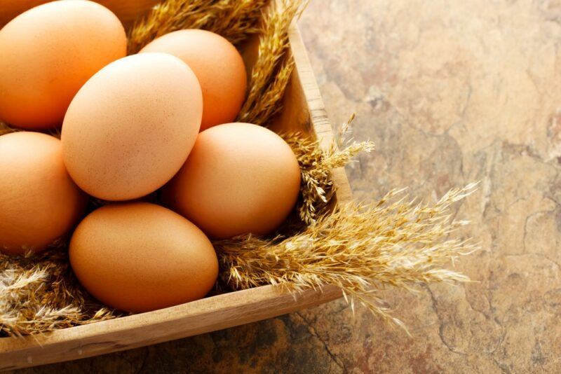 A basket of fresh eggs on a table