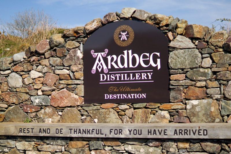 A bench with a quote in front of the Ardbeg Scotch whisky distillery