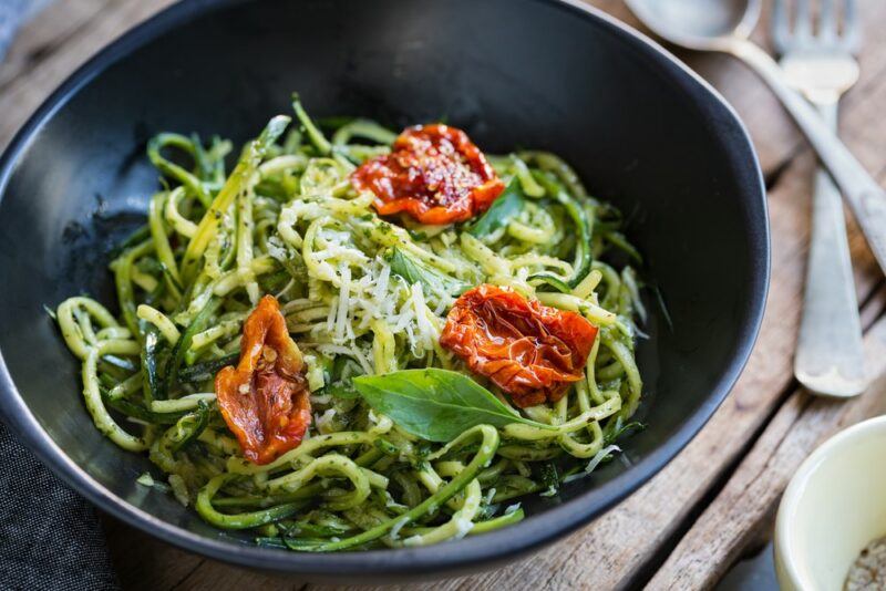 A black pan with zoodles and sundried tomatoes