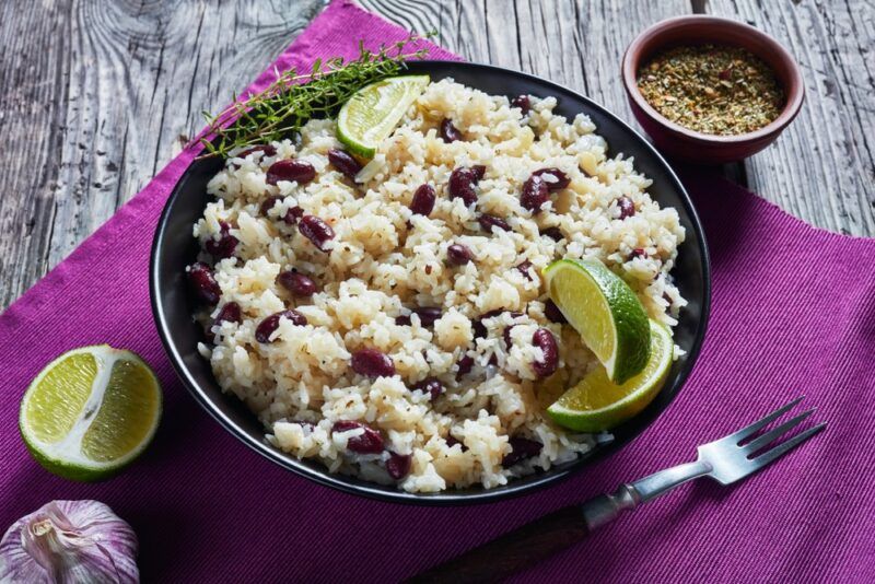 A black dish filled with a rice and peas meal