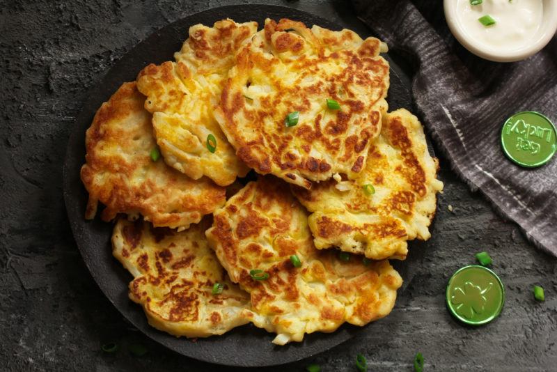 A black dish of potato cakes