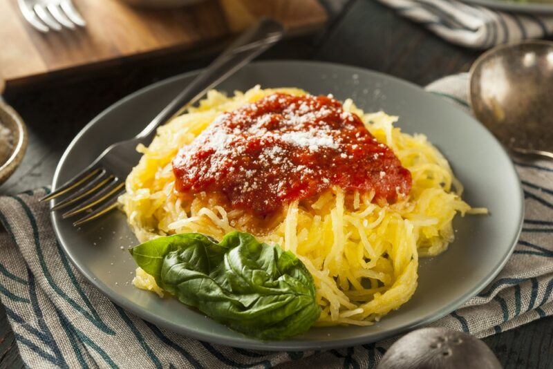 A black dish with spaghetti squash with marinara on top