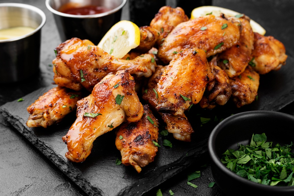 A black piece of slate with chicken wings