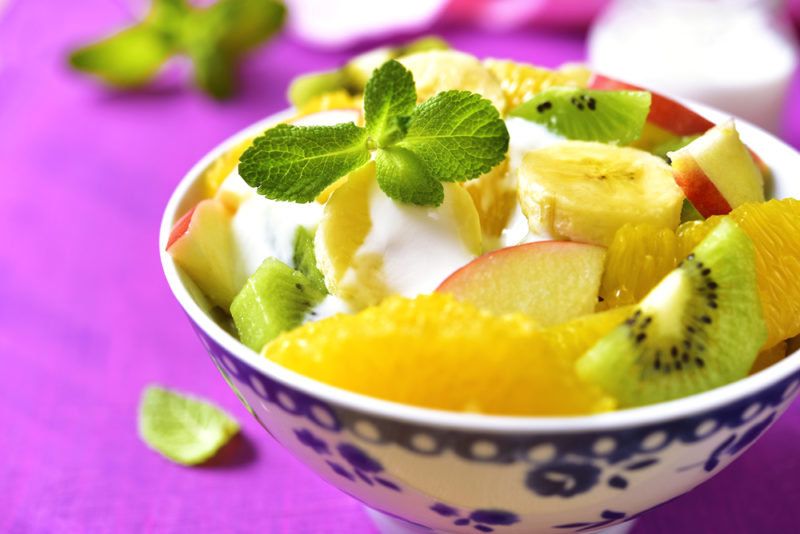 A blue and white bowl with a fruit salad