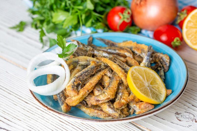 A large blue dish with fried anchovies