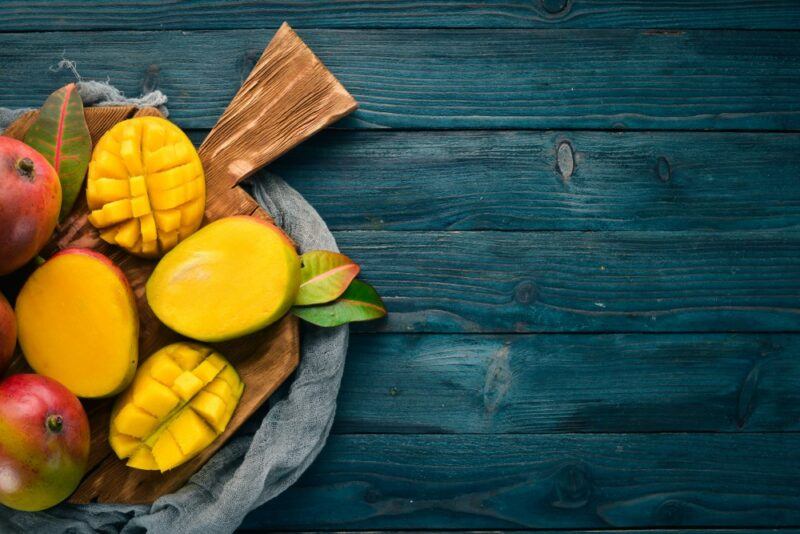 A blue table with mango pieces