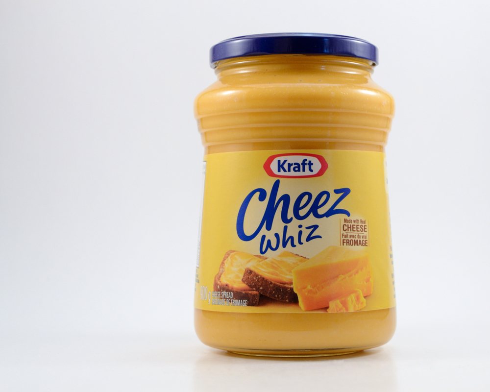 A jar of Kraft Cheez Whiz against a white background