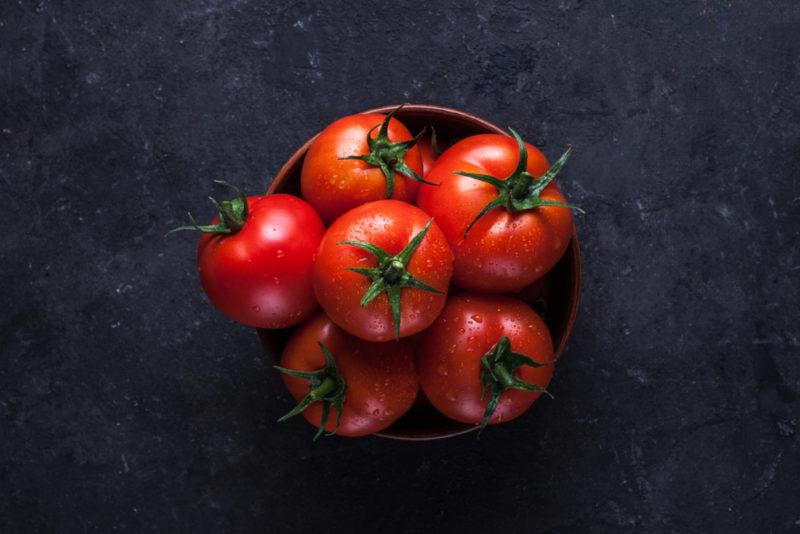 A small black bowl filled with fresh tomatoes