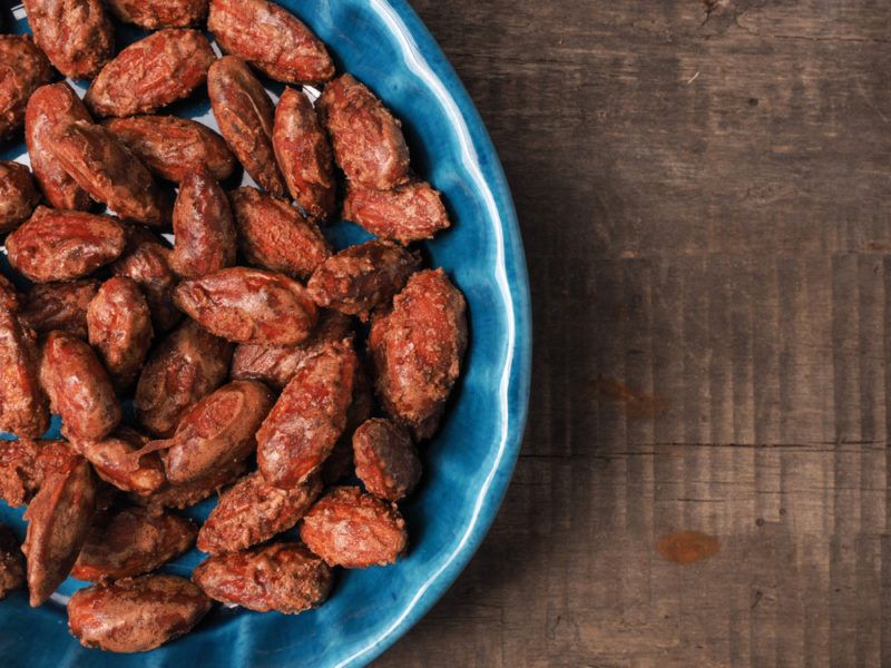 A blue dish of roasted almonds