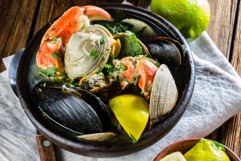 A black bowl with a selection of shellfish