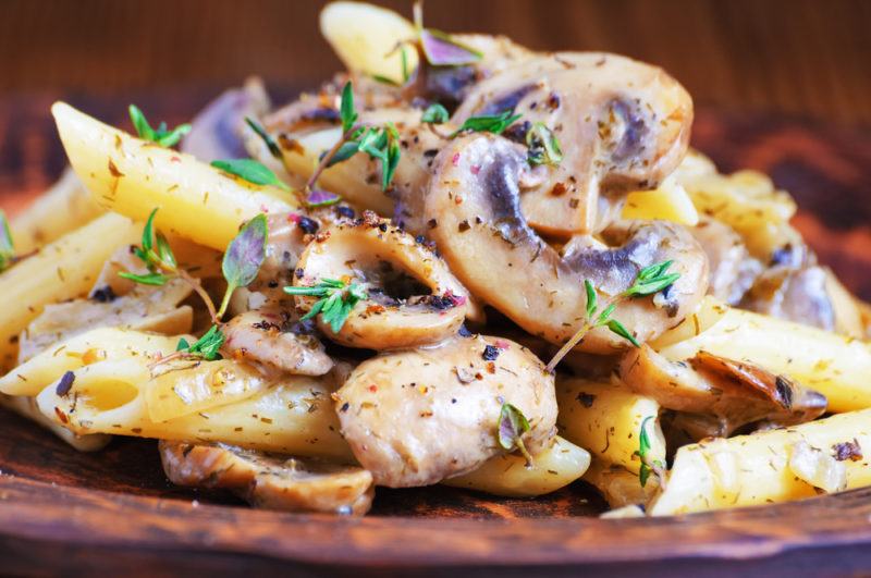 A dish of penne pasta with mushrooms