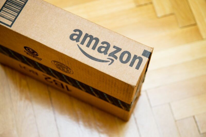 A single Amazon box on a wooden floor