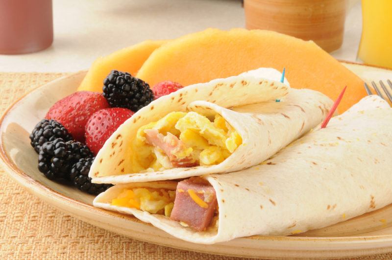 Two breakfast burritos and fruit