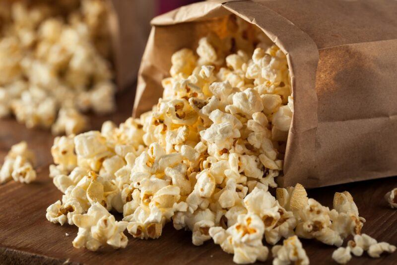 A brown bag filled with popped popcorn