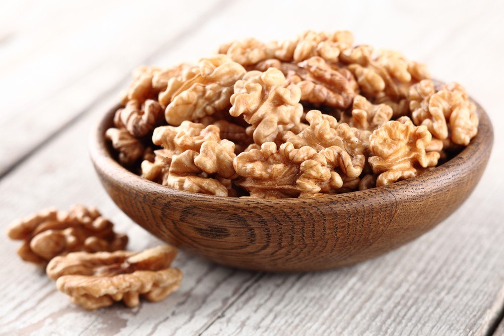 A wooden bowl of walnuts