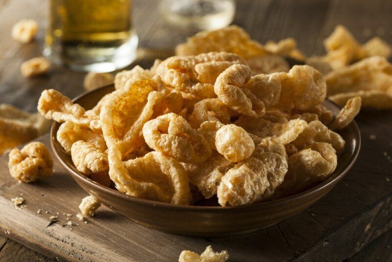 A large brown dish containing fried pork rinds